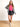 Model is wearing a black faux leather mini skirt with side slit.