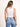 Model is wearing a white high neck crop tank.